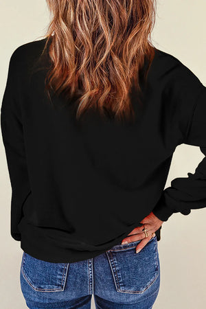 Black crewneck sweatshirt with glitter "Spooky" graphic detail.