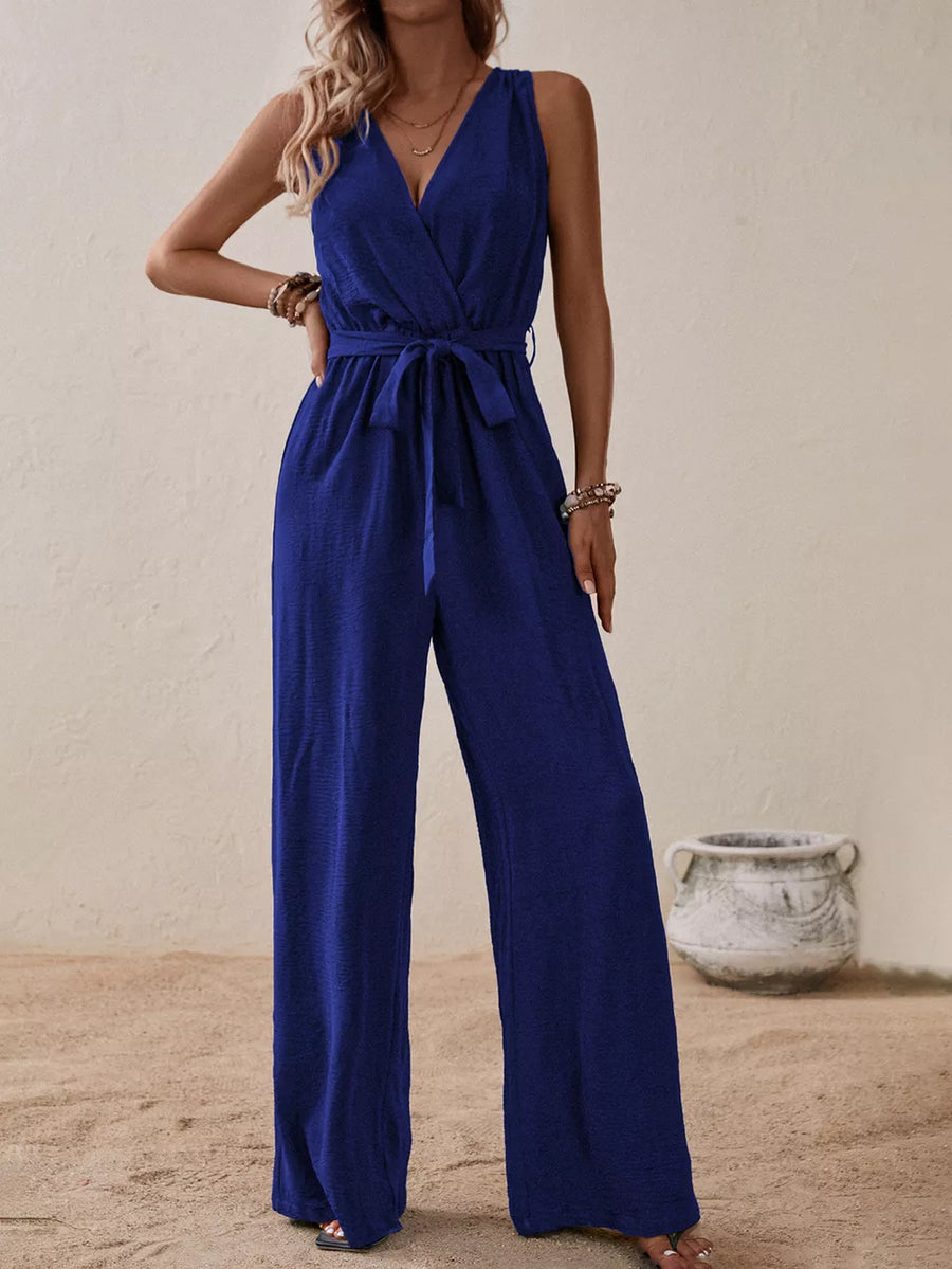 Royal blue V-neck tie-waist wide-leg romper with textured fabric and sleeveless design.