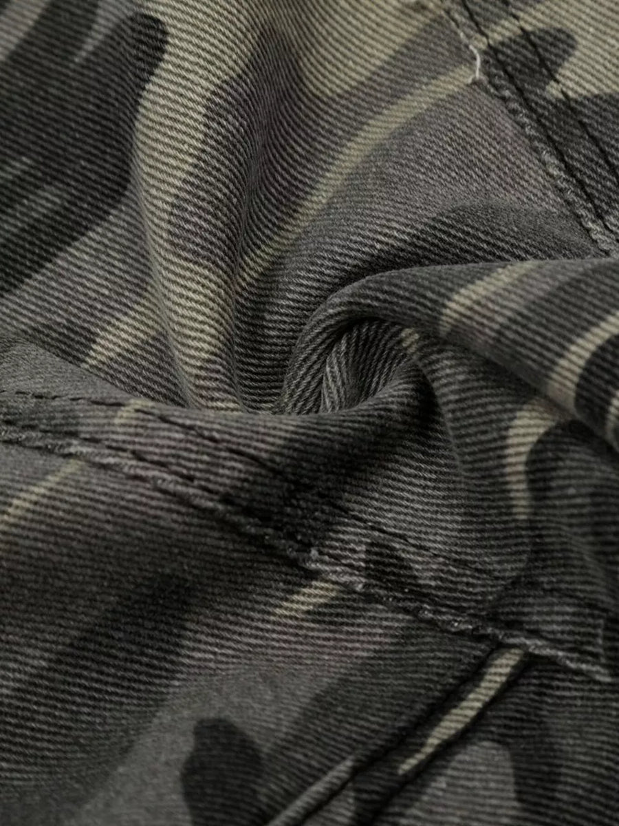 Camouflage cargo capris in cotton with utility pockets and button fly detail.
