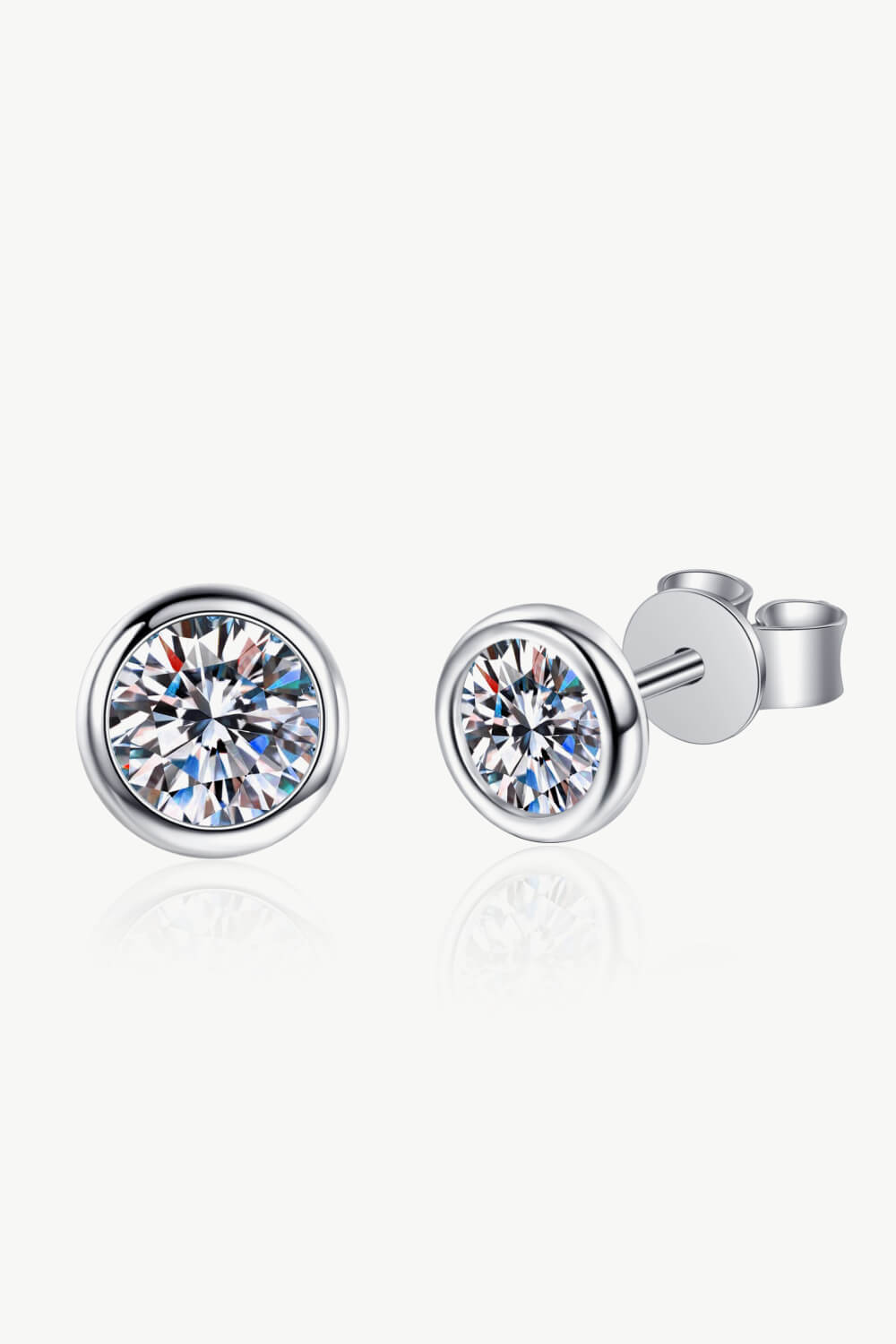 Prismatic Halo Stud Earrings in silver with a clear, faceted gemstone set in a bezel.