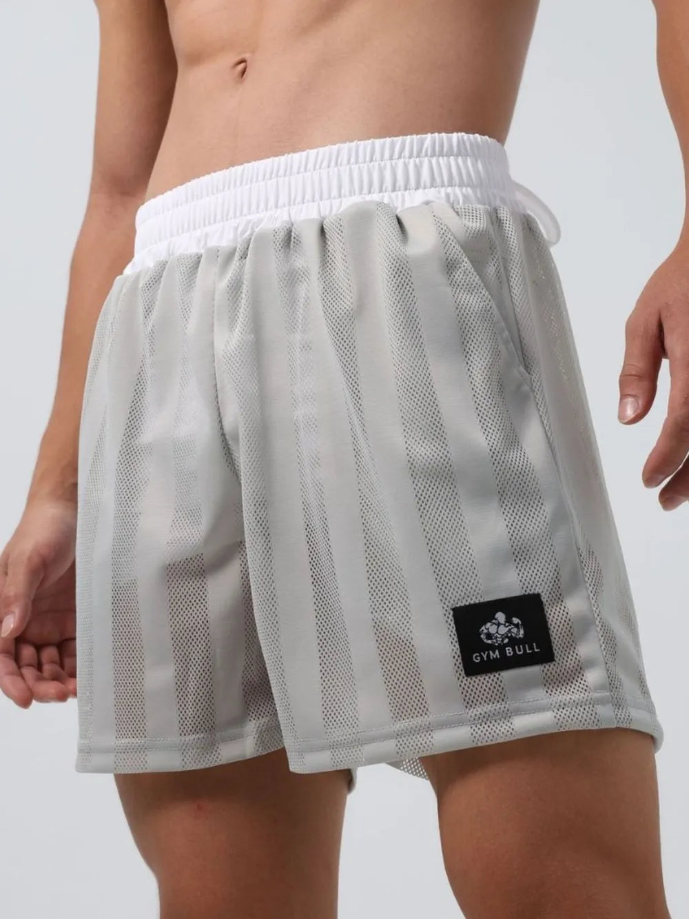 Gray performance mesh training shorts with vertical stripes and white waistband.