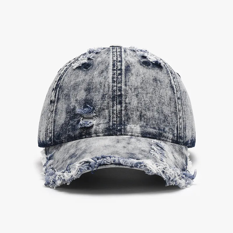 Acid wash frayed denim baseball cap with distressed details and raw edge brim.