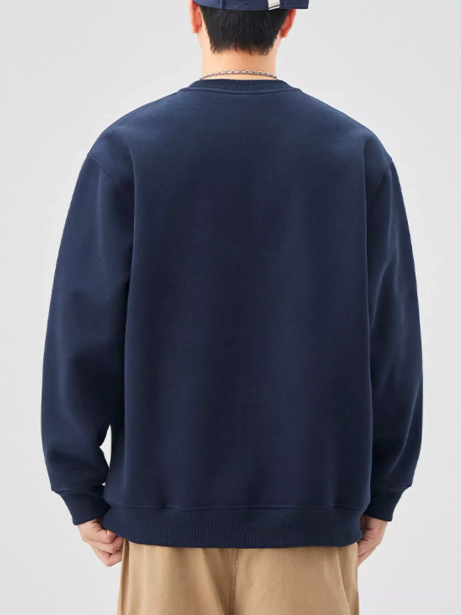 Navy blue oversized graphic sweatshirt with crewneck and ribbed cuffs.