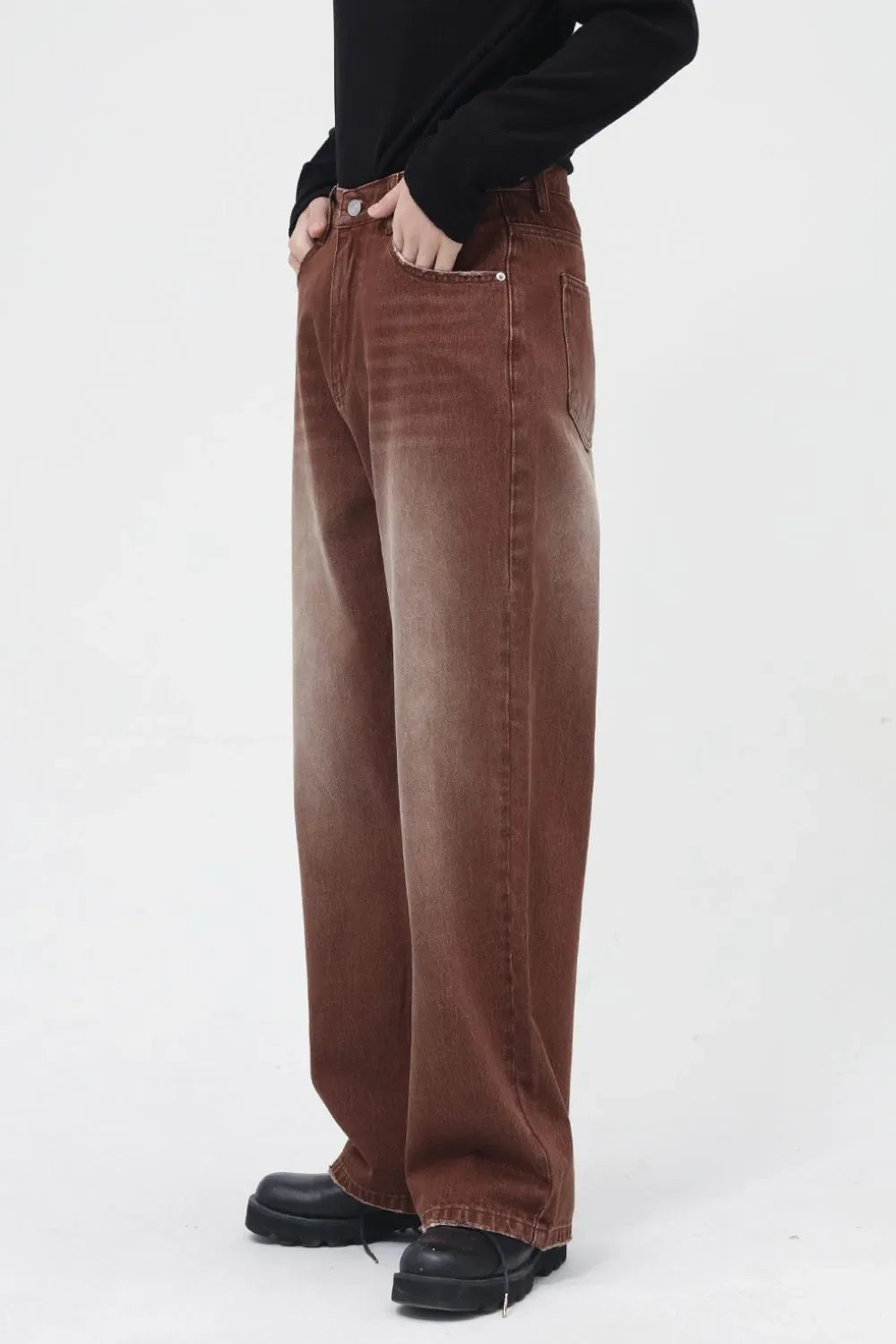 Faded wash brown wide leg denim trousers with a casual, relaxed fit.