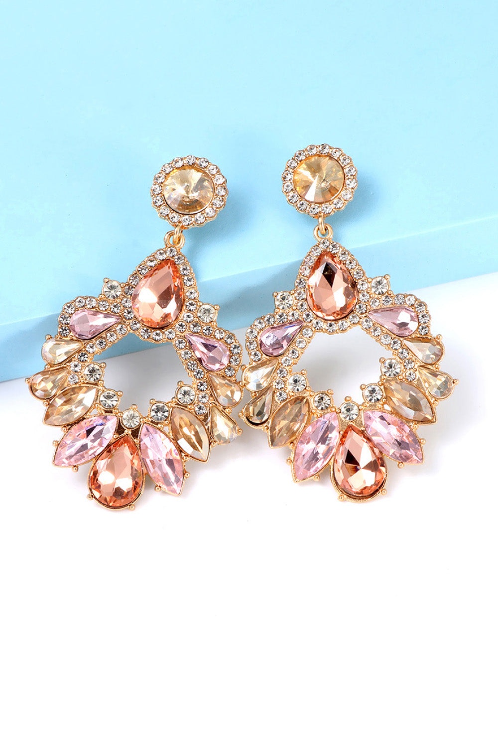 Jeweled chandelier drop earrings in multicolor with pink and peach stones and clear crystals.