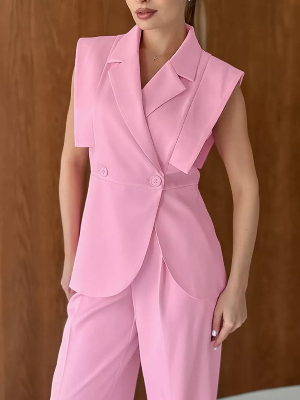 95% polyester, 5% spandex Care instructions: Machine wash cold two-piece set in Pink with fitted top, wide-leg bottom