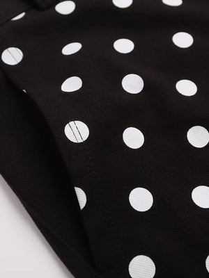 Black polka dot cargo shorts with a visible pocket detail.