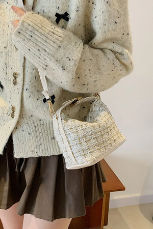 Tweed box bag in ivory with gold threads and detachable strap, styled with a speckled cardigan.