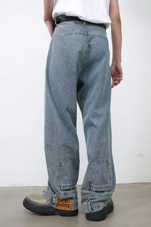 Baggy medium wash denim jeans with distressed detailing and patch pockets.