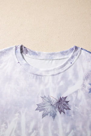 Crew neck t-shirt with a faded purple and white tie-dye pattern and a leaf print.