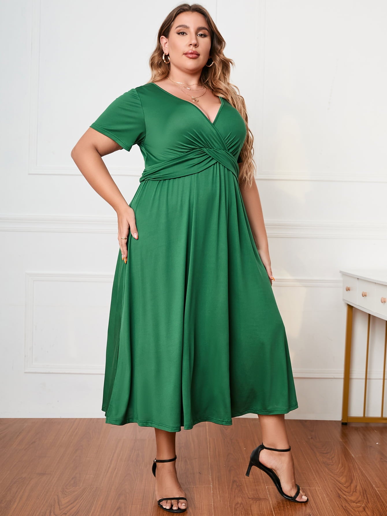 Emerald twist-front midi dress in dark green with short sleeves and a V-neck.