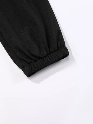 Black sweatpants with elasticated cuffs and subtle butterfly embellishment detail.