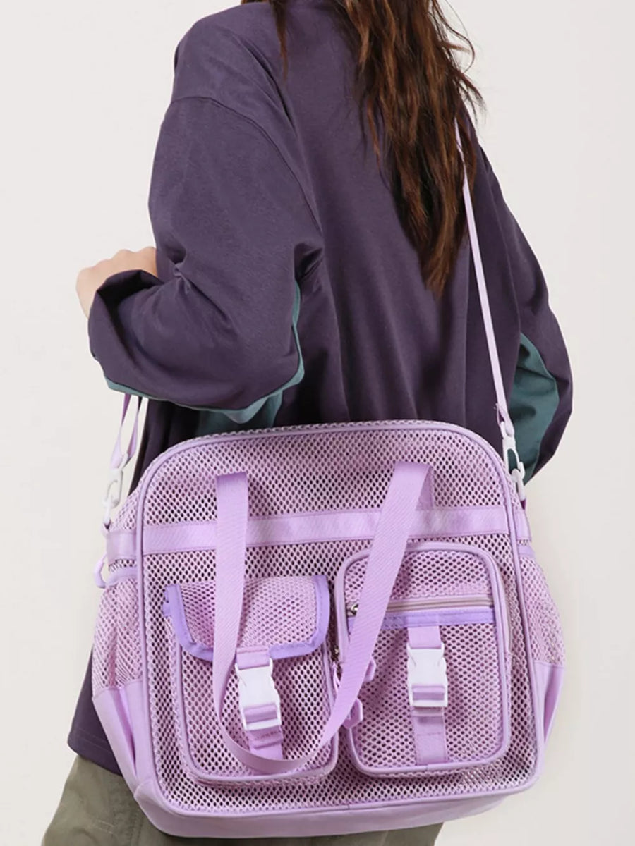 Lavender mesh crossbody bag with unique buckle accents and multiple pockets.