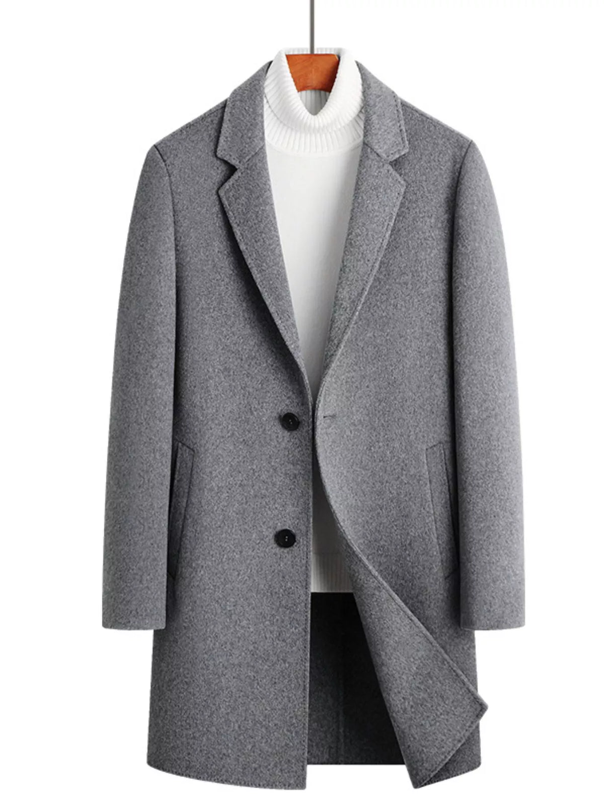 Men's gray wool blend overcoat with two buttons and notched lapels, styled over a white turtleneck.
