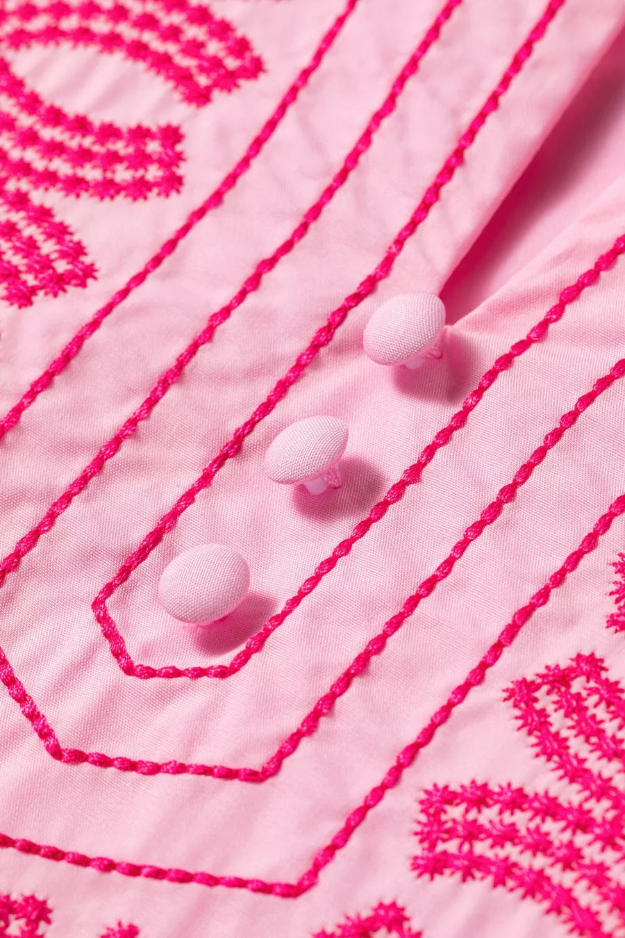Pink cotton shirt with bright pink embroidery and button detail