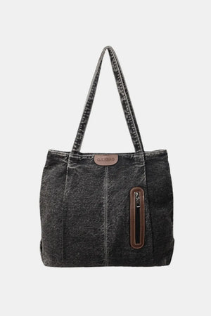 Denim shopper tote bag with leather trim and zip pocket in dark wash.
