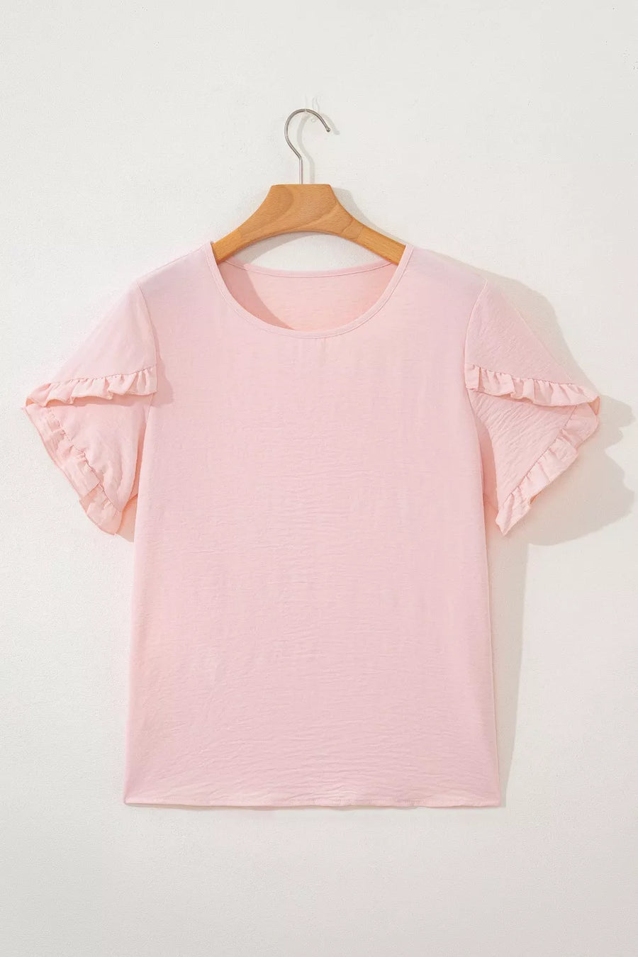 Blush pink polyester short sleeve blouse with ruffle trim on sleeves