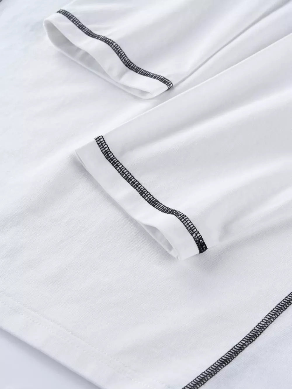 White t-shirt featuring contrast stitching and graphic