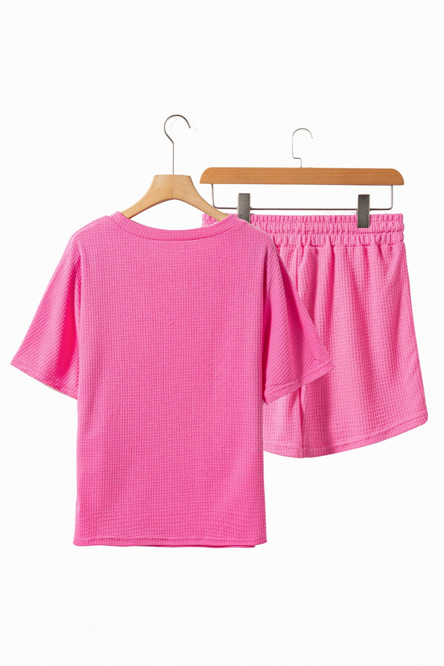 Hot pink waffle knit co-ord set with short sleeve top and elastic waist shorts.
