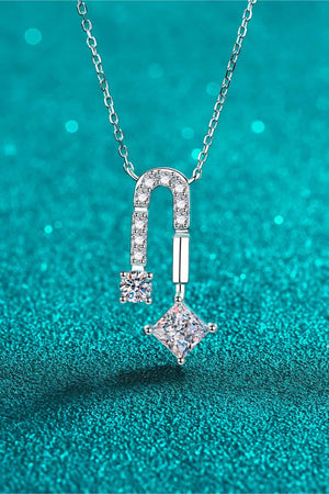 Silver geometric moissanite pendant necklace with a horseshoe shape and square-cut stone.