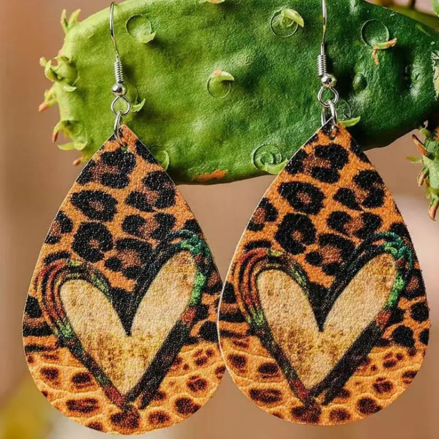 Leopard print teardrop earrings with a colorful heart detail.