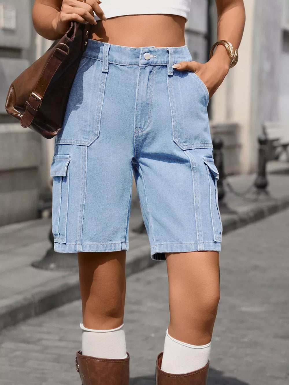 Light blue denim high-waisted cargo shorts with multiple pockets and contrast stitching.