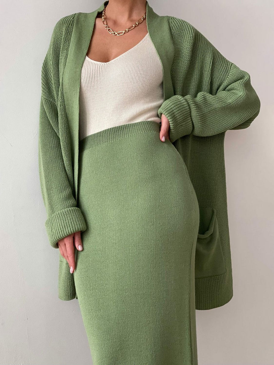 Ribbed knit co-ord set in Gum Leaf green, featuring a long cardigan with pockets and a midi skirt.