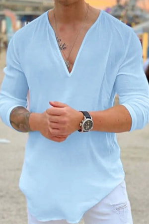Pastel blue linen relaxed fit top with deep V-neck and long sleeves.