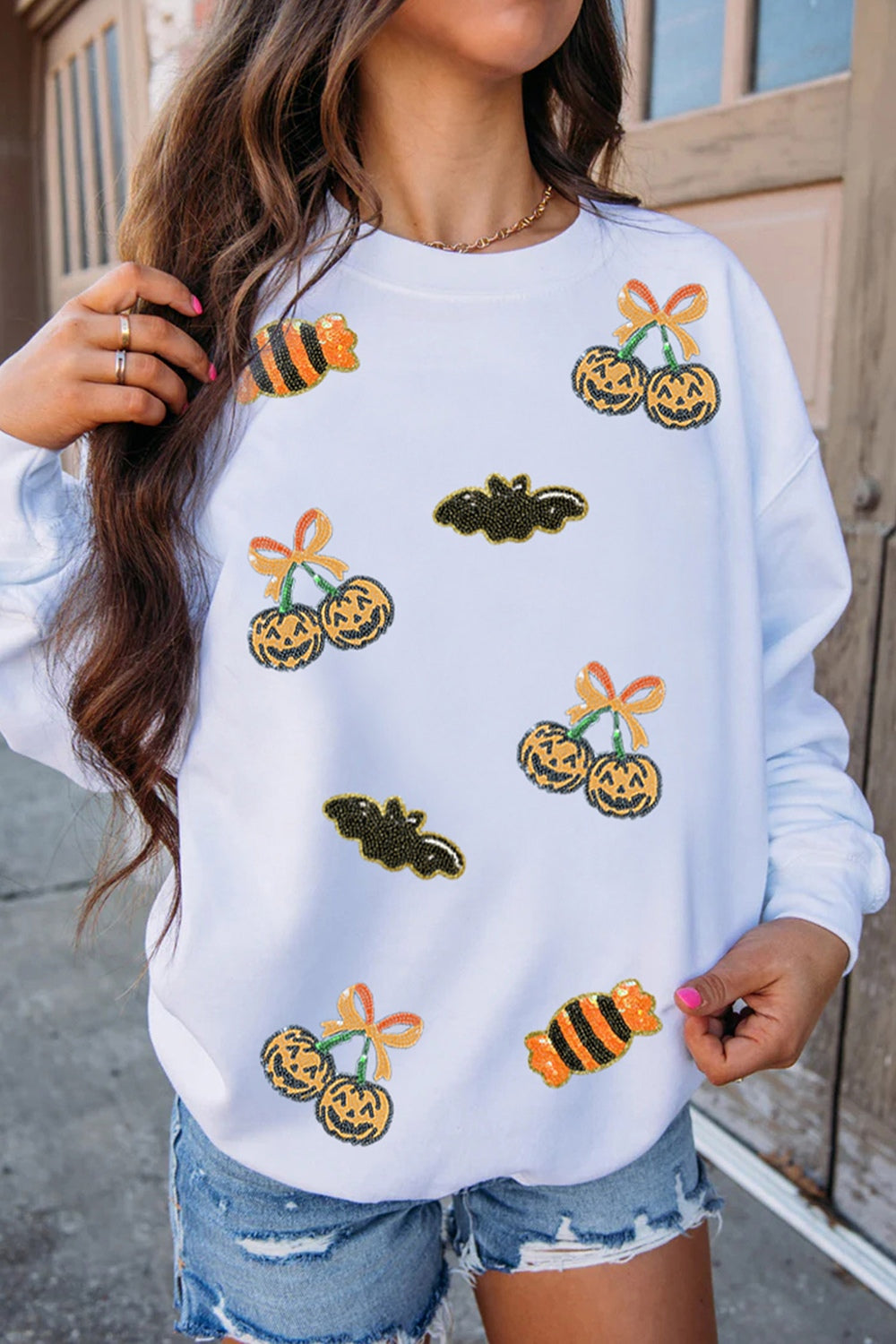 white pullover sweater with graphic print and crew neck