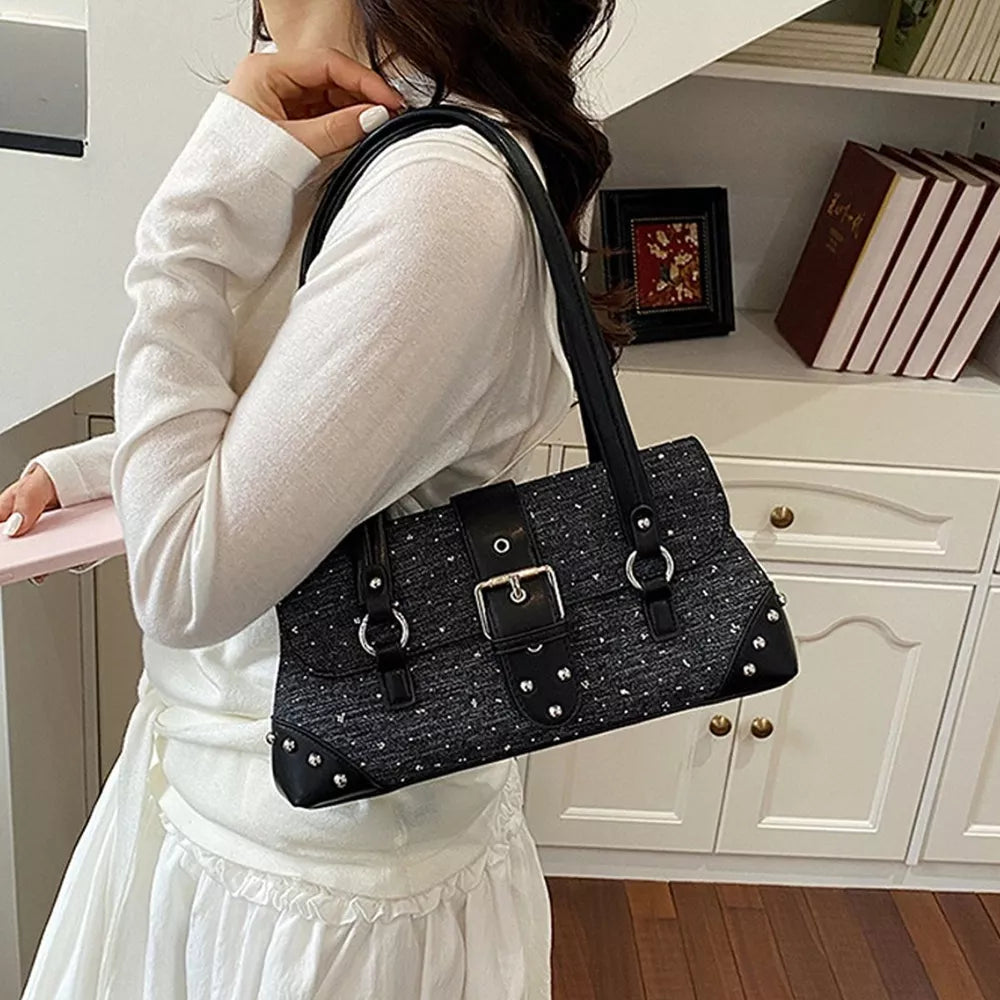 black handbag with medium and flap closure