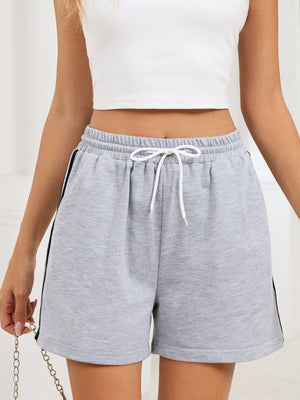 Heathered gray jogger shorts with white drawstring and sporty black side trim.