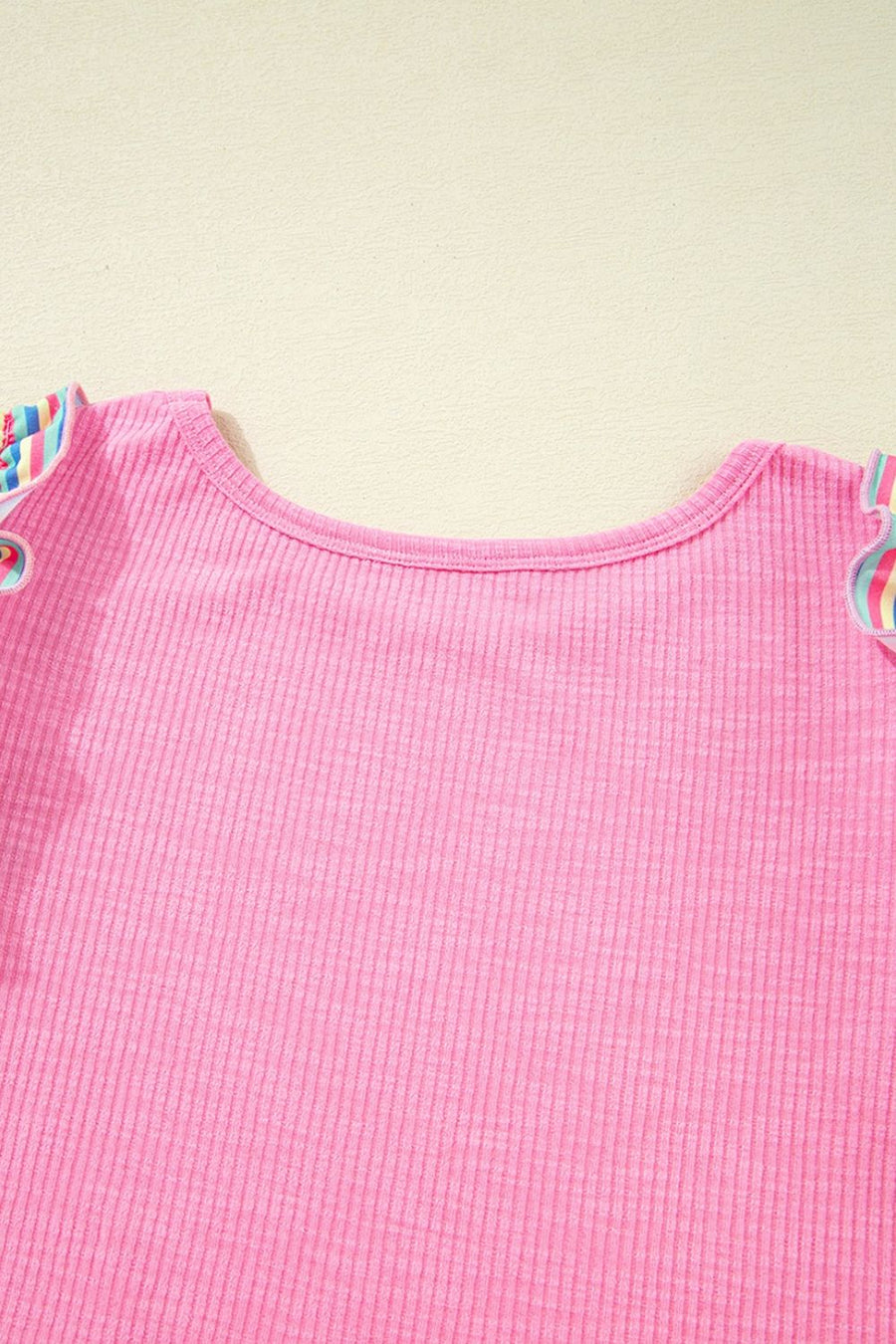 Pink ribbed knit top with pastel stripe sleeve detail