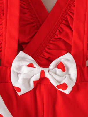 Red baby outfit with heart print bow detail and ruffled neckline.