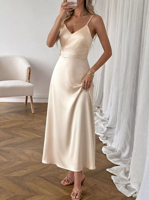 Cream satin V-neck maxi dress with spaghetti straps and ruched waist detail.