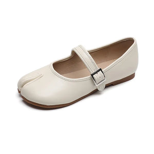 Beige tabi Mary Jane flats with a single strap and silver buckle closure.