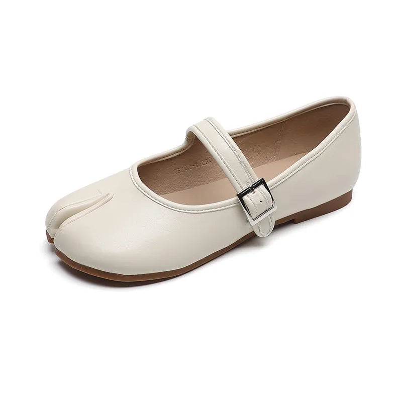 Beige tabi Mary Jane flats with a single strap and silver buckle closure.