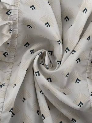 White fabric with fan and diamond pattern, ruffled trim