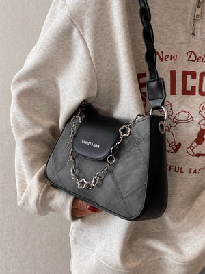 Textured grey shoulder bag with black flap and decorative chain strap