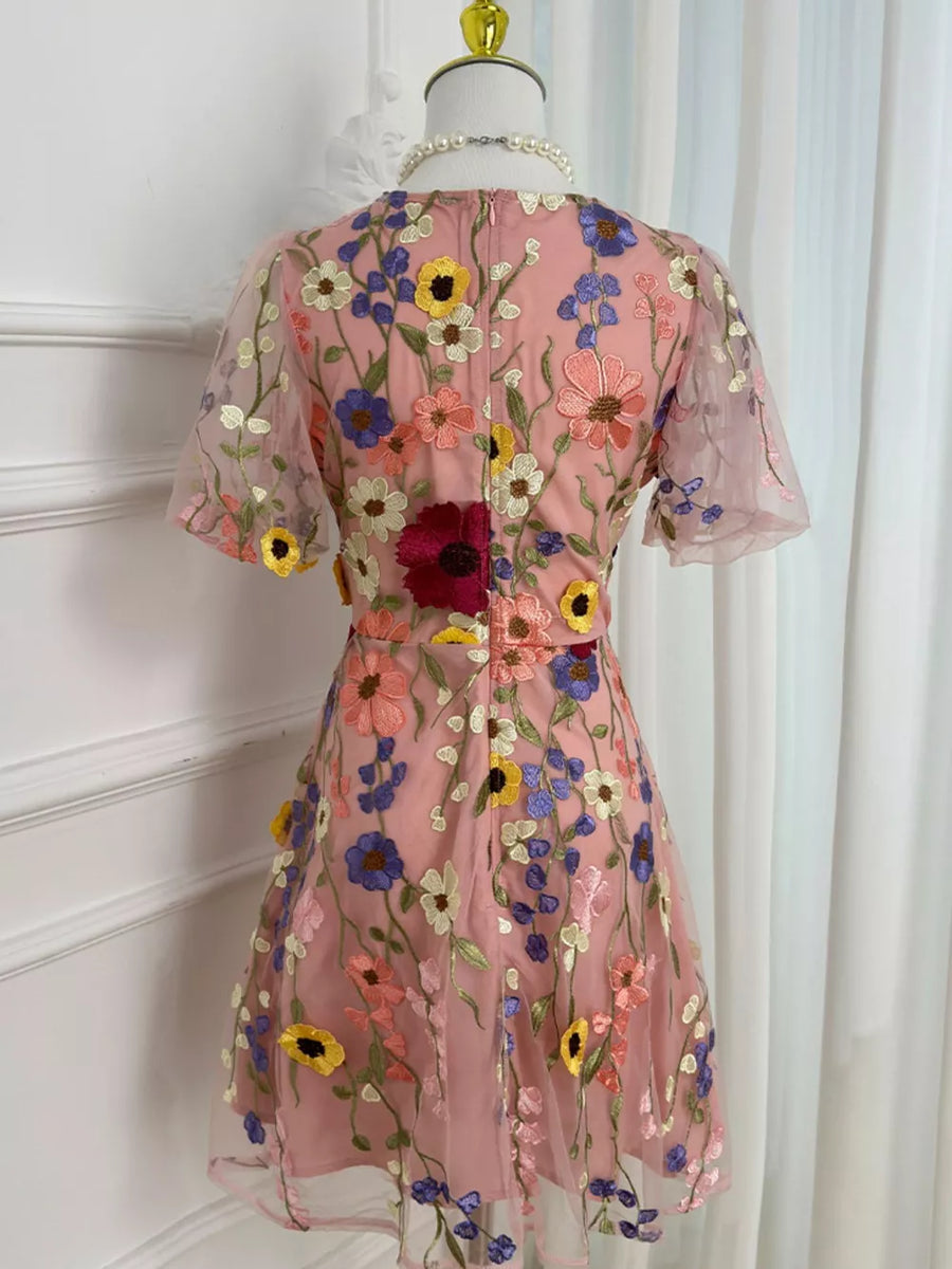 Pink floral embroidered mesh dress with short sleeves and a flared skirt.