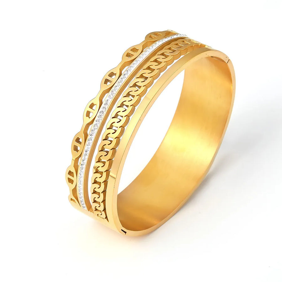 Gold cuff bracelet with layered chain and crystal details