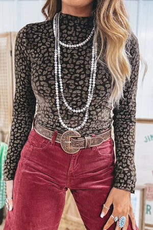 Textured leopard print fitted pullover shirt with mock neck and long sleeves.