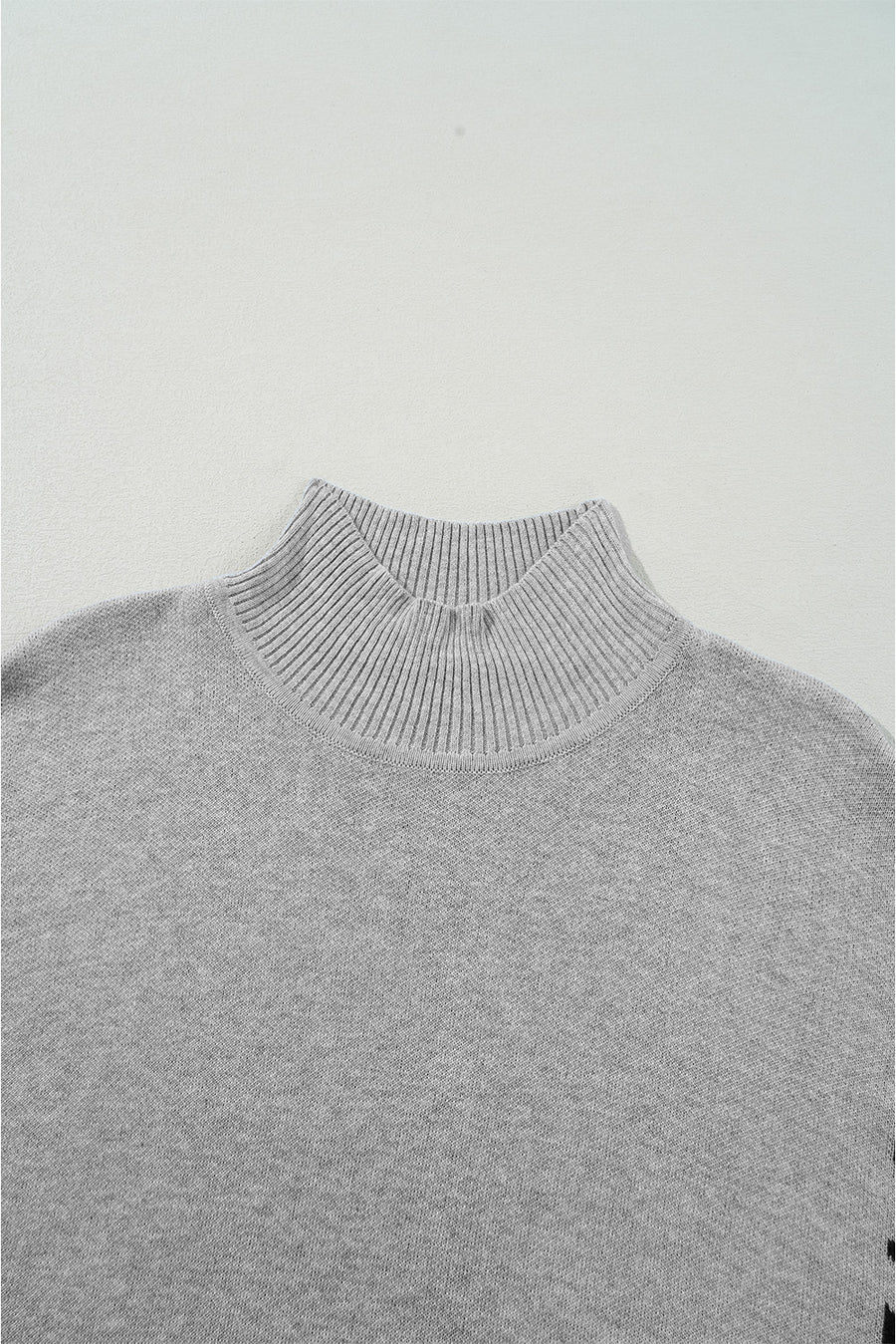 Gray acrylic knit sweater with mock neck and asymmetric leopard panel detail.