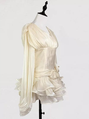 White ruffled mini dress with corset waist and draped sleeves