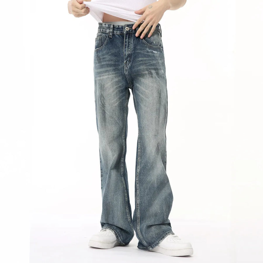 Baggy distressed denim flare jeans in medium wash with a relaxed fit.