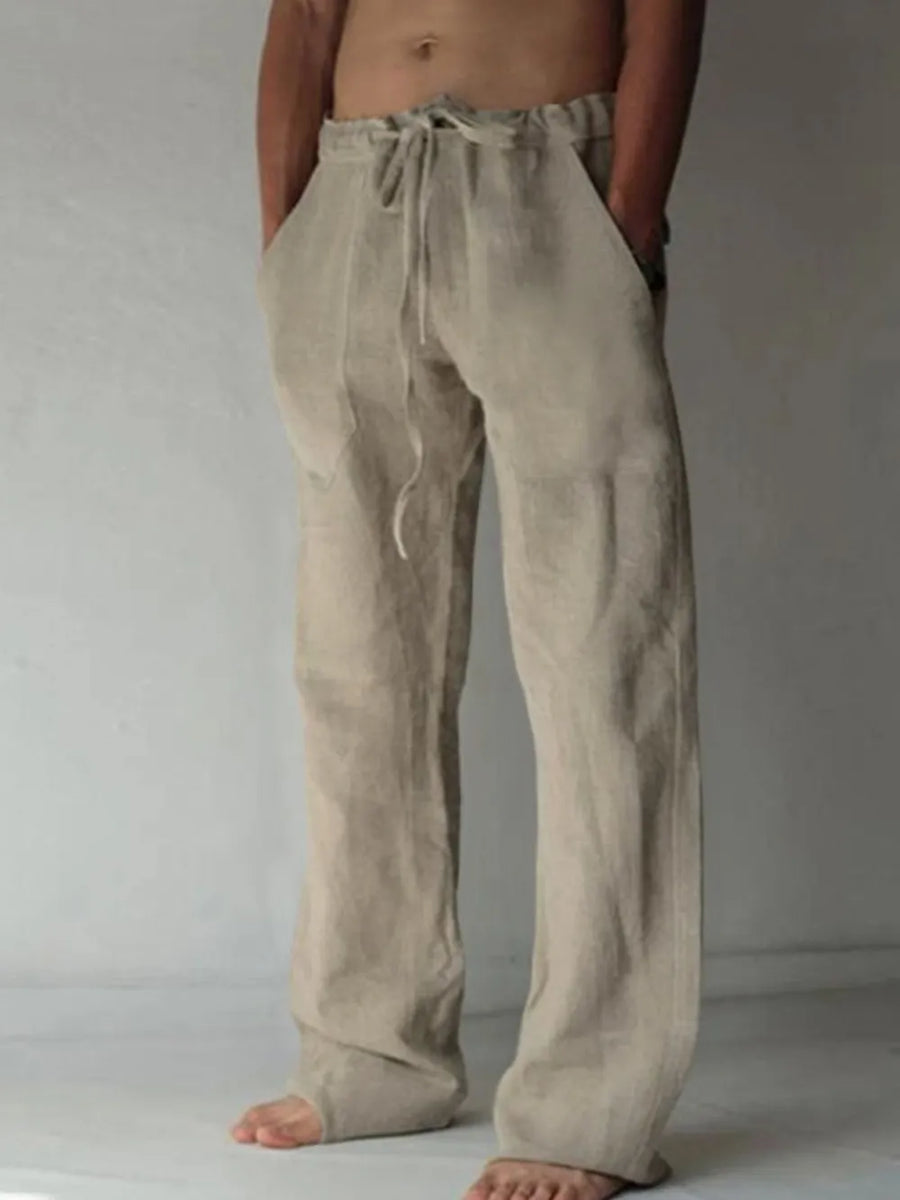 Tan linen blend wide-leg drawstring trousers with pockets.