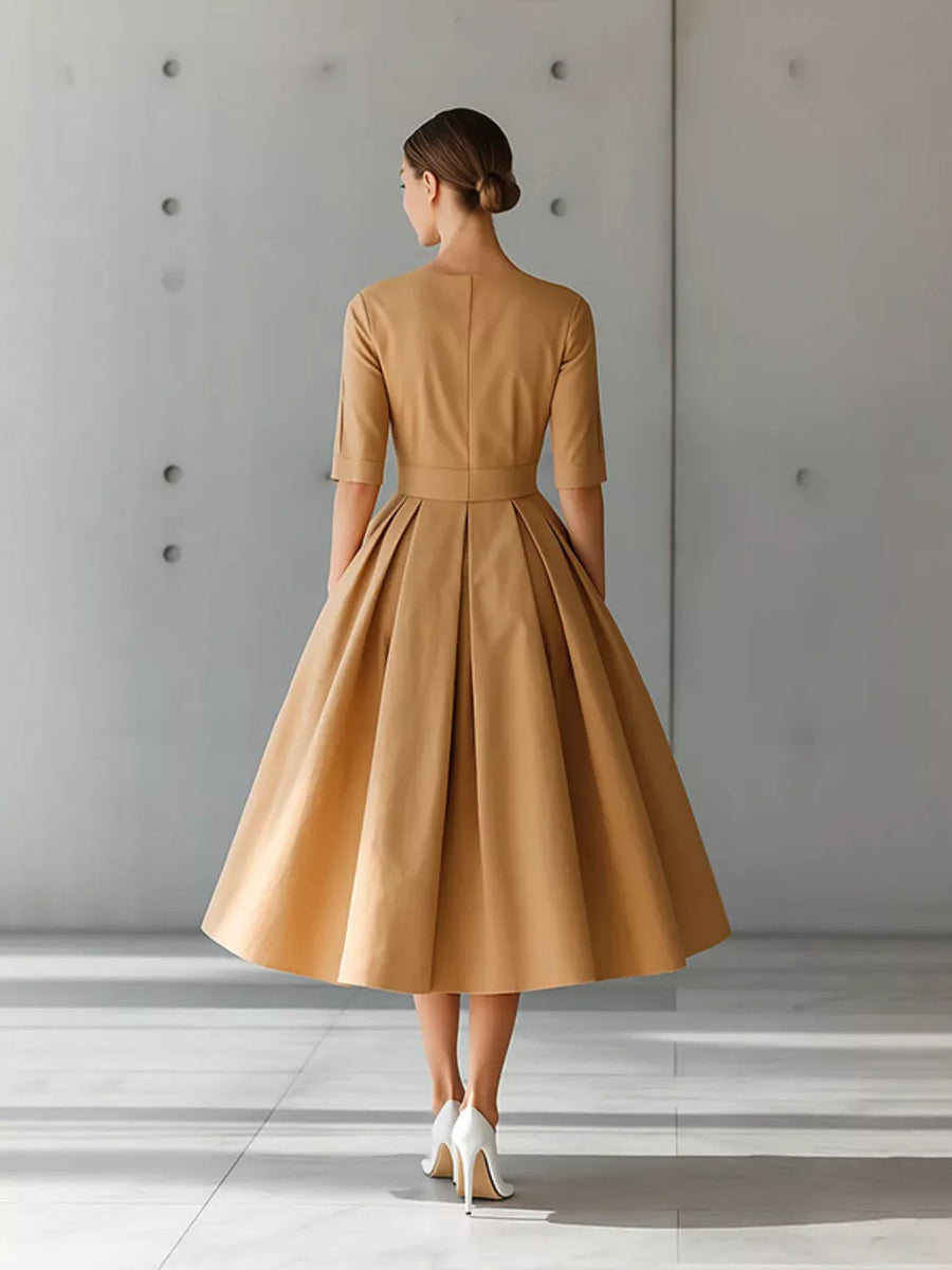Camel A-line midi dress with pleated skirt and three-quarter sleeves.