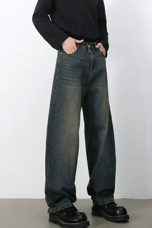 Faded baggy denim jeans in a dark blue wash with a relaxed fit.