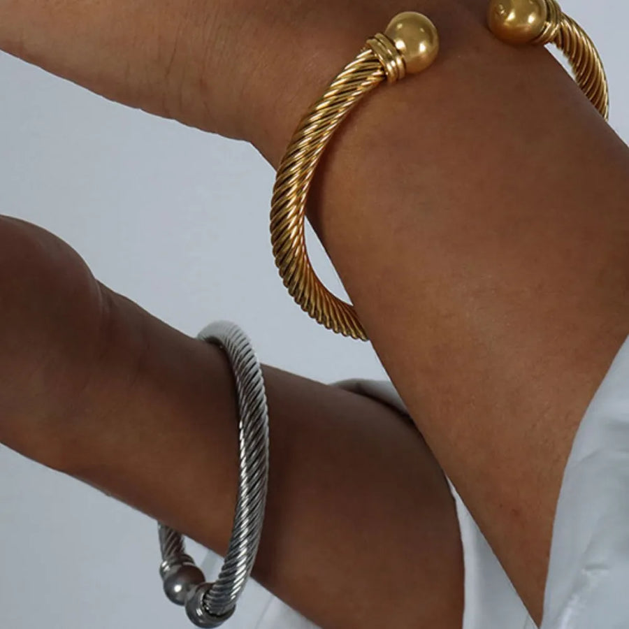 bracelet in gold featuring twisted cable design and open cuff fit