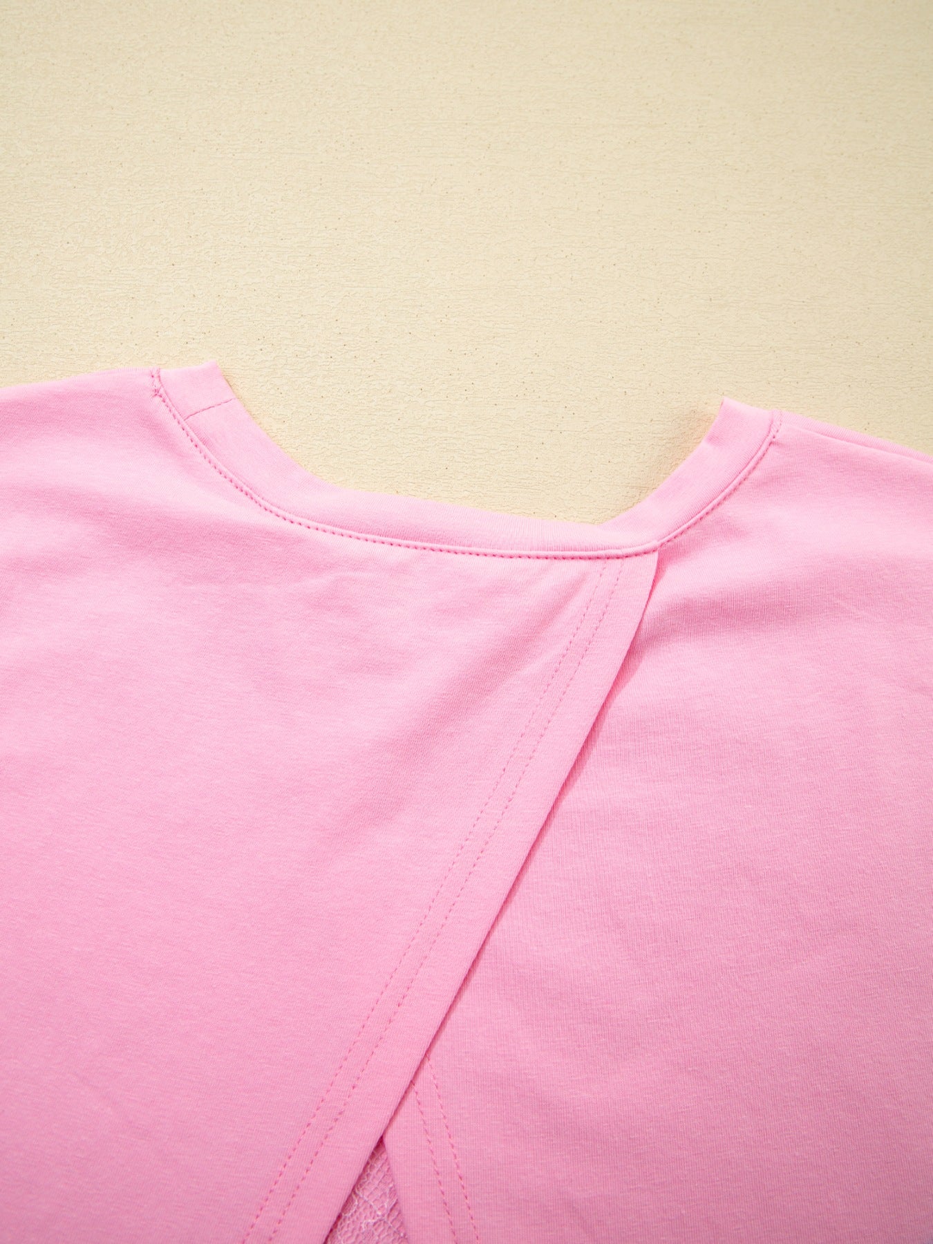 Pink cotton blend oversized tee with a crossover back detail.