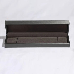 Open dark gray jewelry box with brown velvet lining